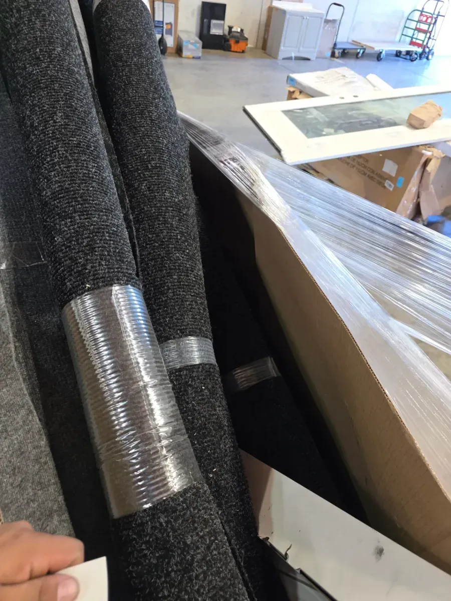 Pallet of Home Goods with Rolled Rugs and Door - image 2