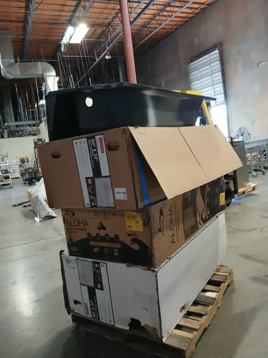 A pallet of bathtubs in various sizes and shapes; one of the four is cracked at the corner. - image 9