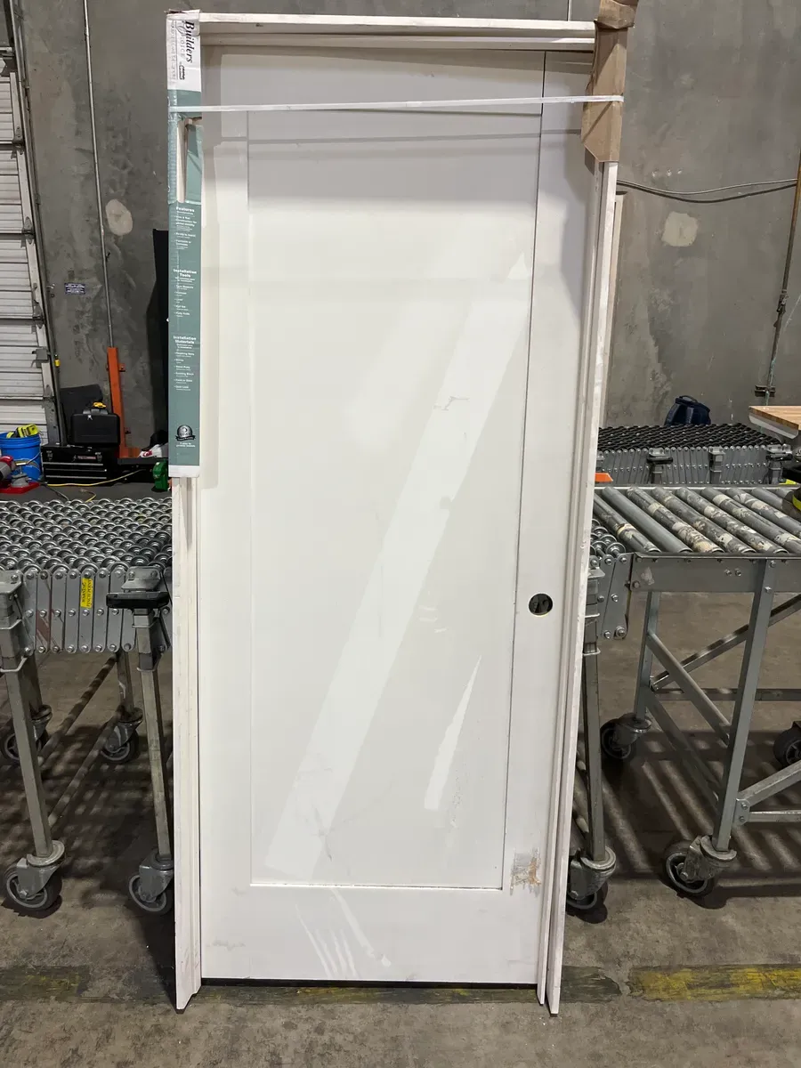 **frame is a little bit of damage in the door has minor dents **32 in. x 80 in. Shaker 1-Panel Primed Solid Hybrid Core MDF Left-Hand Single Prehung Interior Door - image 3
