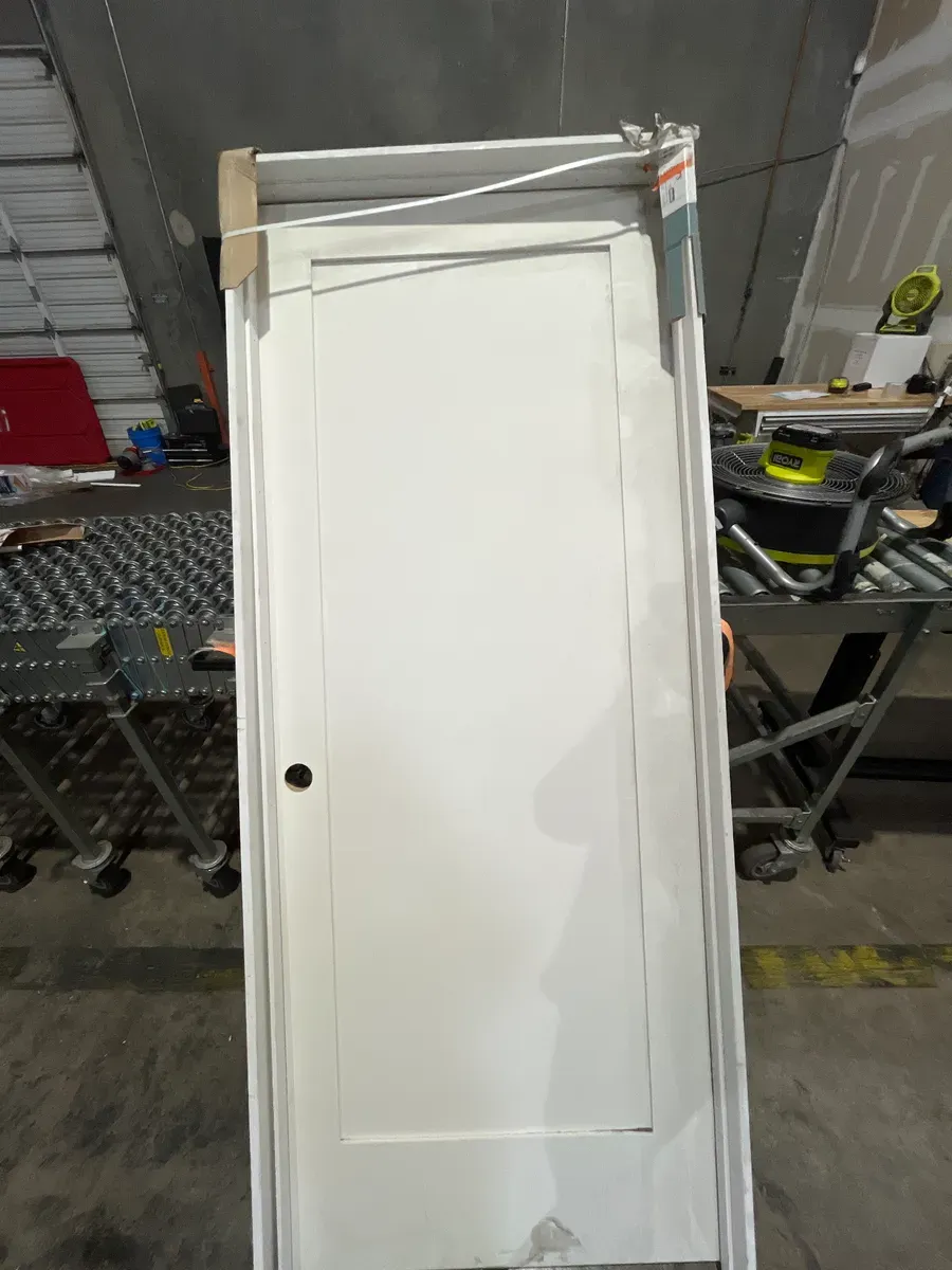 **frame is a little bit of damage in the door has minor dents **32 in. x 80 in. Shaker 1-Panel Primed Solid Hybrid Core MDF Left-Hand Single Prehung Interior Door - image 3