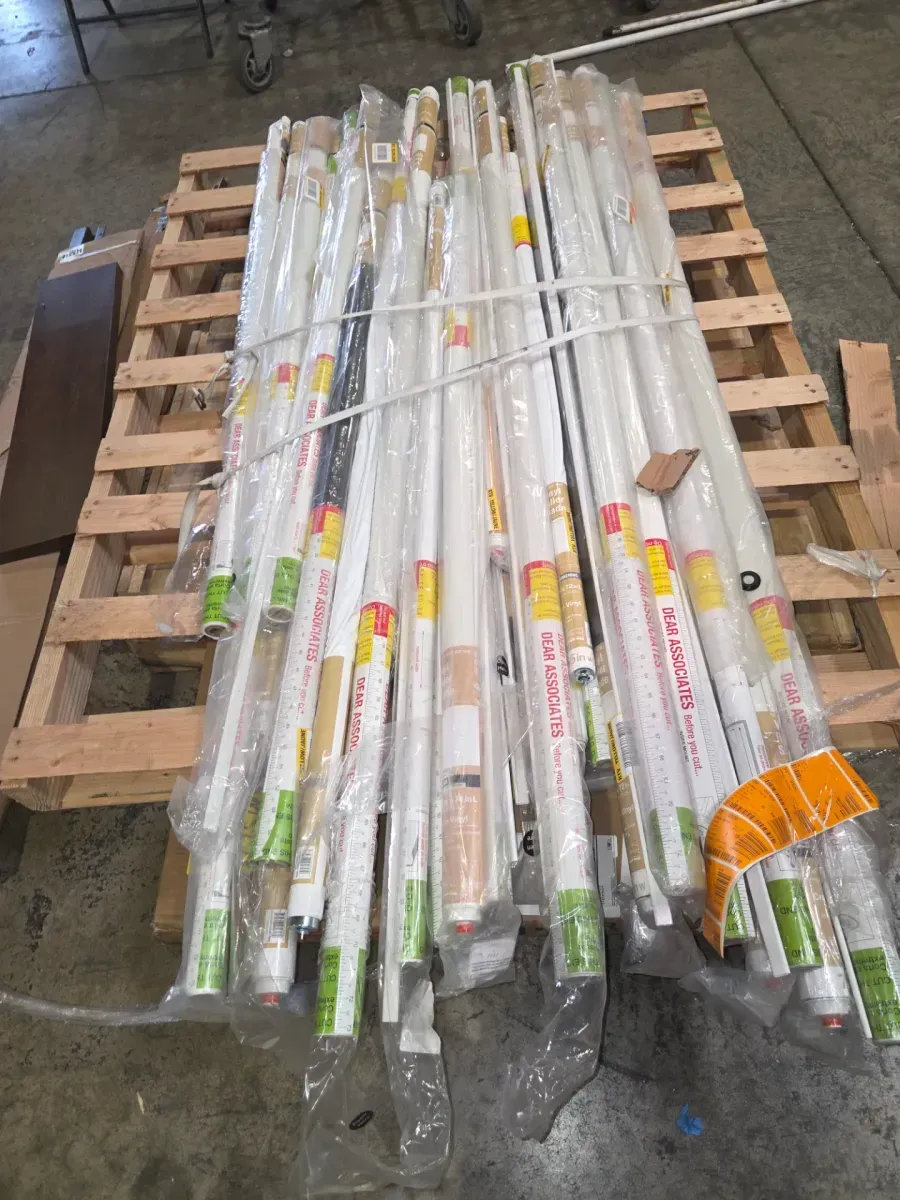 Pallet of 30 cordless blackout vinyl roller shades in various sizes and colors. - image 1