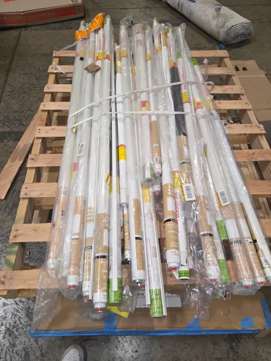 Pallet of 30 cordless blackout vinyl roller shades in various sizes and colors. - image 2