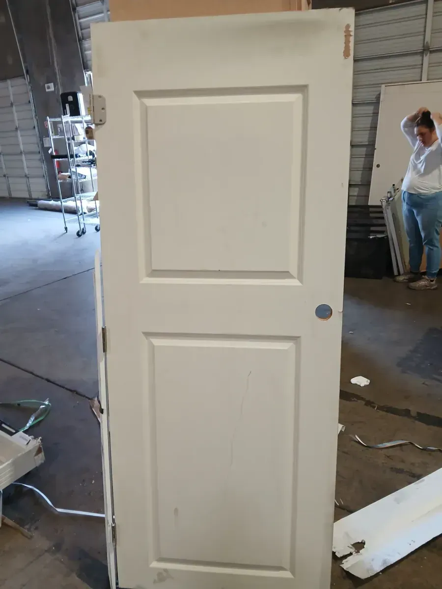 **has minor dents and the frame is broken **32 in. x 80 in. Primed 2-Panel Square Hollow Core Composite Interior Door Slab - image 2
