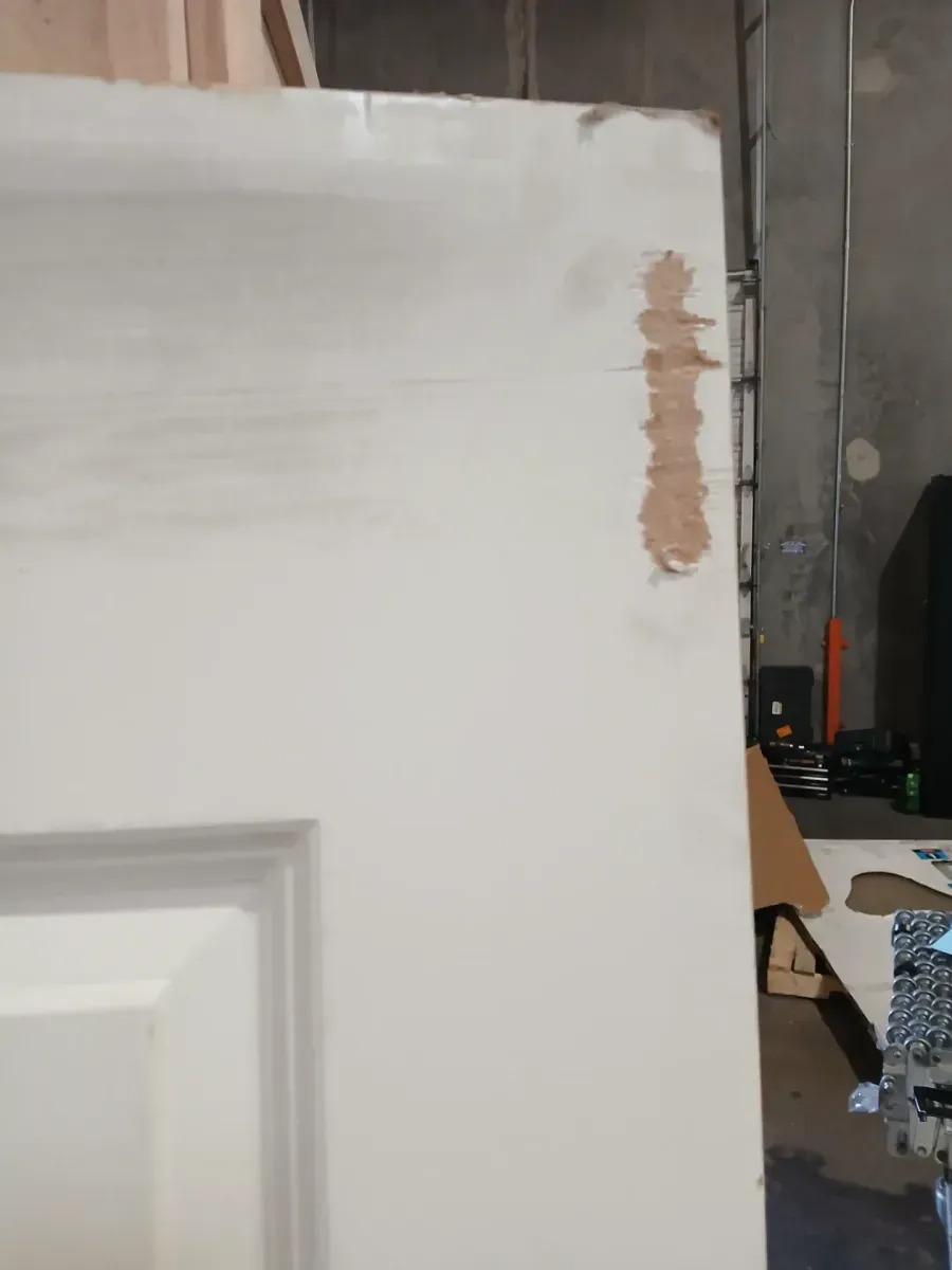 **has minor dents and the frame is broken **32 in. x 80 in. Primed 2-Panel Square Hollow Core Composite Interior Door Slab - image 3