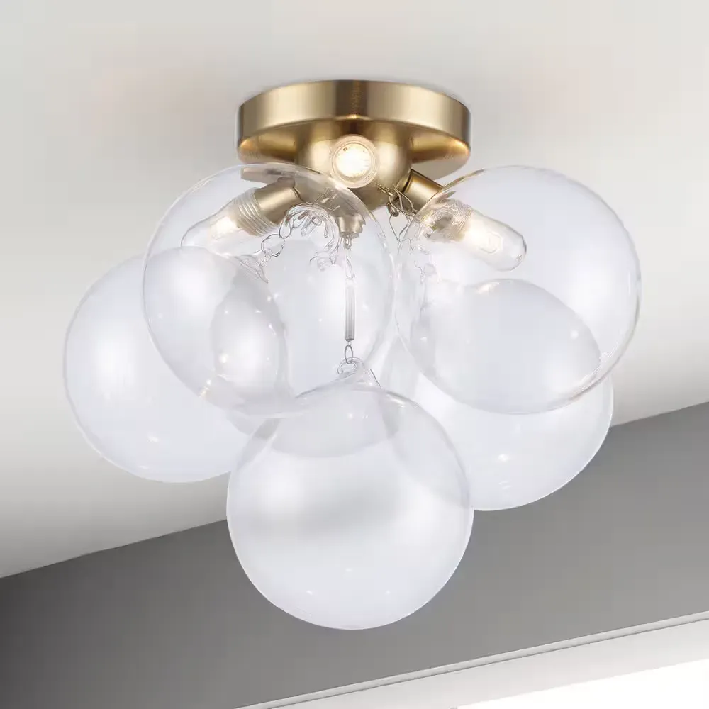 Aurora 13.3 in. 3-Light Gold Flush Mount Ceiling Light with Clear Glass Globe Shades and Halogen Light Bulbs Included - image 1